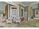 Covered patio features a collection of furniture, with a brick wall and blue painted ceiling at 435 Jackson St, Locust Grove, GA 30248