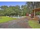 Expansive pool area surrounded by lush greenery, featuring classic statuary and a red barn in the background at 435 Jackson St, Locust Grove, GA 30248