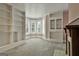 Bright sitting room features carpet floors, built-in shelves, a fireplace, and a bay window at 435 Jackson St, Locust Grove, GA 30248