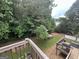 Lush backyard featuring mature trees, mulched areas, and a charming playhouse at 639 Sheffield Ct, Villa Rica, GA 30180