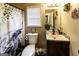 Charming bathroom featuring a decorative shower curtain, and well-lit vanity with mirror at 639 Sheffield Ct, Villa Rica, GA 30180