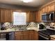 Modern kitchen boasting granite countertops, stainless steel appliances, and a stylish backsplash at 639 Sheffield Ct, Villa Rica, GA 30180