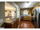 Spacious kitchen featuring stainless steel appliances, granite countertops, and wood flooring at 639 Sheffield Ct, Villa Rica, GA 30180