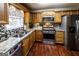 Well-equipped kitchen featuring stainless steel appliances, granite countertops, and wood cabinets at 639 Sheffield Ct, Villa Rica, GA 30180