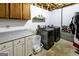 Functional laundry room featuring newer washer and dryer units, storage cabinets and concrete flooring at 639 Sheffield Ct, Villa Rica, GA 30180