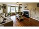 Cozy living room featuring natural light, a ceiling fan, and a charming fireplace at 639 Sheffield Ct, Villa Rica, GA 30180