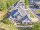Stunning aerial view of a large home with gray shingles and a stone facade, nestled in a well-maintained neighborhood at 100 Harmony Ct, Dallas, GA 30157