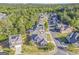 Aerial view of a residential neighborhood with lush green trees and well-maintained homes at 100 Harmony Ct, Dallas, GA 30157