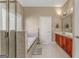 Bright bathroom features tile floors, double vanity and large soaking tub with decorative window at 100 Harmony Ct, Dallas, GA 30157