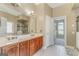 Elegant bathroom featuring dual sinks, wood cabinets, tile floor, and glass-enclosed shower at 100 Harmony Ct, Dallas, GA 30157