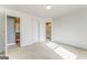 Neutral bedroom with plush carpeting, white walls, and doorways leading to other rooms at 100 Harmony Ct, Dallas, GA 30157