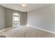 Bright bedroom featuring a large arched window and neutral carpet at 100 Harmony Ct, Dallas, GA 30157