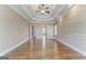 Spacious bedroom with tray ceiling, hardwood floors, decorative wall trim and neutral color palette at 100 Harmony Ct, Dallas, GA 30157