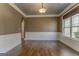 Traditional dining room boasts hardwood floors, modern lighting, and elegant trim work at 100 Harmony Ct, Dallas, GA 30157