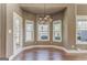 Cozy dining area features hardwood floors, a modern chandelier, and plenty of natural light at 100 Harmony Ct, Dallas, GA 30157