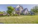Charming two-story home with stone and siding exterior, well-manicured lawn, and lush landscaping at 100 Harmony Ct, Dallas, GA 30157