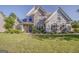 Beautiful two-story home with a stone facade, elegant windows, and lush landscaping at 100 Harmony Ct, Dallas, GA 30157