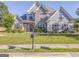 Charming two-story home with a stone facade, manicured lawn, and beautiful landscaping at 100 Harmony Ct, Dallas, GA 30157