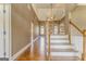 Grand foyer with hardwood floors, arched doorways, staircase, and ample natural light at 100 Harmony Ct, Dallas, GA 30157