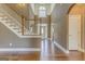 Grand foyer featuring high ceilings, hardwood floors, elegant staircase, and abundant natural light at 100 Harmony Ct, Dallas, GA 30157