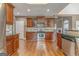 Well-equipped kitchen with stainless steel appliances, tiled backsplash, and hardwood flooring throughout at 100 Harmony Ct, Dallas, GA 30157