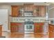 Kitchen featuring modern stainless steel appliances and elegant cherry wood cabinets at 100 Harmony Ct, Dallas, GA 30157