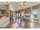 Open-concept living room with stone fireplace, hardwood floors, and seamless connection to the dining area at 100 Harmony Ct, Dallas, GA 30157