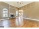 Spacious living room with hardwood floors, stone fireplace, and natural light from large windows at 100 Harmony Ct, Dallas, GA 30157