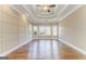 Spacious living room featuring hardwood floors, tray ceiling, and large windows for plenty of natural light at 100 Harmony Ct, Dallas, GA 30157
