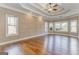 Spacious living room featuring hardwood floors, tray ceilings, recessed lighting, and large windows at 100 Harmony Ct, Dallas, GA 30157