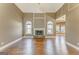 Bright living room with hardwood floors, stone fireplace, and arched windows offering natural light at 100 Harmony Ct, Dallas, GA 30157