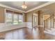 Open-concept living and dining area featuring hardwood floors, large window, and modern decor at 100 Harmony Ct, Dallas, GA 30157