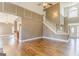 Bright, open-concept living room features hardwood floors and elegant staircase with white trim at 100 Harmony Ct, Dallas, GA 30157