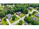 Stunning aerial view of a red brick home with lush green lawns and mature trees in a beautiful neighborhood setting at 1621 White Oak Cv, Loganville, GA 30052
