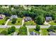 Picturesque aerial view of a charming red brick home featuring a well-manicured lawn and lush green trees at 1621 White Oak Cv, Loganville, GA 30052