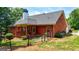 Backyard view featuring a covered patio, fenced yard, and lush greenery, perfect for outdoor enjoyment at 1621 White Oak Cv, Loganville, GA 30052