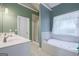 This bathroom features a tub and shower, providing a luxurious space to relax and unwind at 1621 White Oak Cv, Loganville, GA 30052