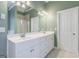 The bathroom features double sinks, a large mirror, and plenty of counter space at 1621 White Oak Cv, Loganville, GA 30052