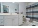 This bathroom features a tub/shower combo, white cabinets, and plenty of counter space at 1621 White Oak Cv, Loganville, GA 30052