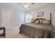 This bedroom features a large bed, ceiling fan, and several doors for easy access at 1621 White Oak Cv, Loganville, GA 30052