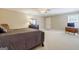 Spacious bedroom features neutral walls, plush carpet, and a ceiling fan for comfort at 1621 White Oak Cv, Loganville, GA 30052