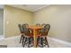 Dining area featuring a wooden table with matching chairs, offering an inviting space at 1621 White Oak Cv, Loganville, GA 30052