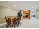 Open floor plan dining area with black chairs and table, next to kitchen at 1621 White Oak Cv, Loganville, GA 30052