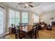 Spacious dining area with a wooden table, hardwood floors, and natural light at 1621 White Oak Cv, Loganville, GA 30052