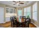 Sunlit dining area with a large wooden table, built-in cabinets, and hardwood floors at 1621 White Oak Cv, Loganville, GA 30052