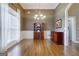 Bright dining room featuring large window, hardwood floors, and classic wainscoting detail at 1621 White Oak Cv, Loganville, GA 30052