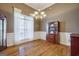 Dining room with beautiful window, hardwood floors, and classic wainscoting at 1621 White Oak Cv, Loganville, GA 30052