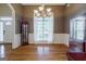 Dining room with beautiful hardwood floors, a chandelier, and a large bright window at 1621 White Oak Cv, Loganville, GA 30052
