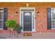 Elegant front door with decorative sidelights, and manicured plants at 1621 White Oak Cv, Loganville, GA 30052