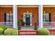 Welcoming front porch with brick accents and decorative plants framing the entryway at 1621 White Oak Cv, Loganville, GA 30052